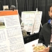 Gaurab Bhattarai, hazelnut breeder with Oregon State University, holds a bowl of Lagerstedt hazelnuts next to an explanatory poster about the new variety at the recent Nut Growers Society winter meeting in Albany, Ore. (Mateusz Perkowski/Capital Press) 